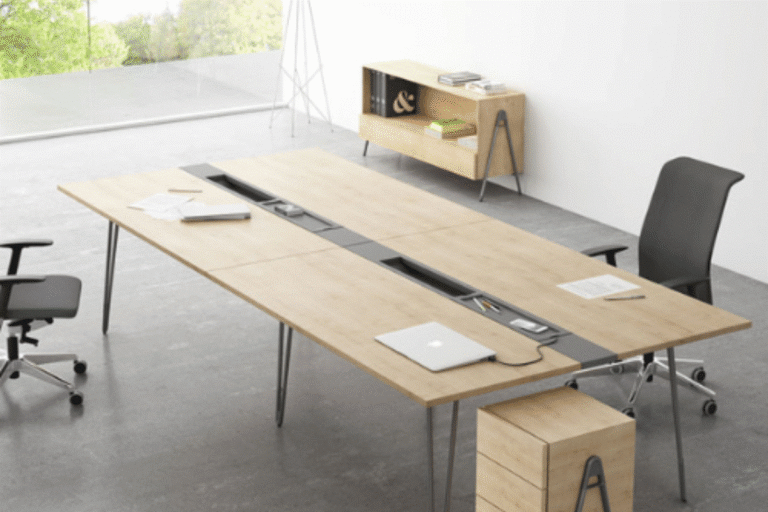 Open-plan office featuring modular workstation desks and cable management